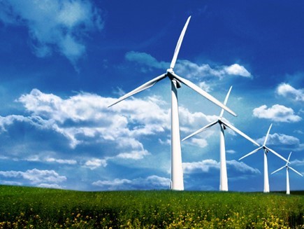 Four wind turbines in an open field